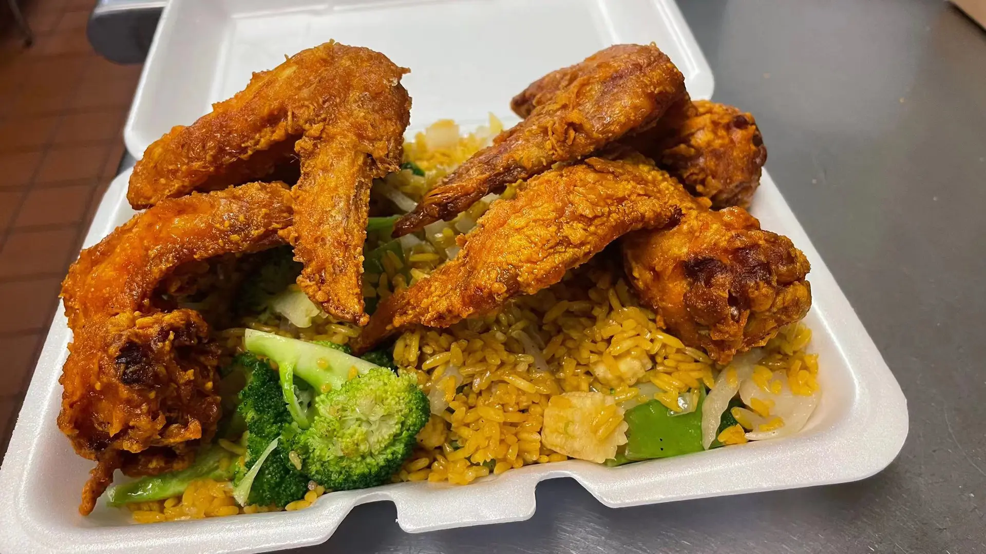 Fried chicken wings served with pork fried rice and broccoli at New Panda Restaurant, a Chinese Restaurant in Garner