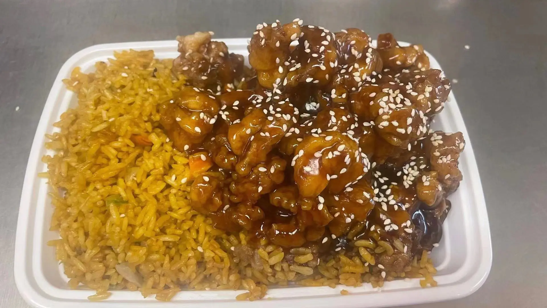 Sesame chicken glazed with sauce and served with fried rice at New Panda Restaurant, a Chinese Restaurant in Garner