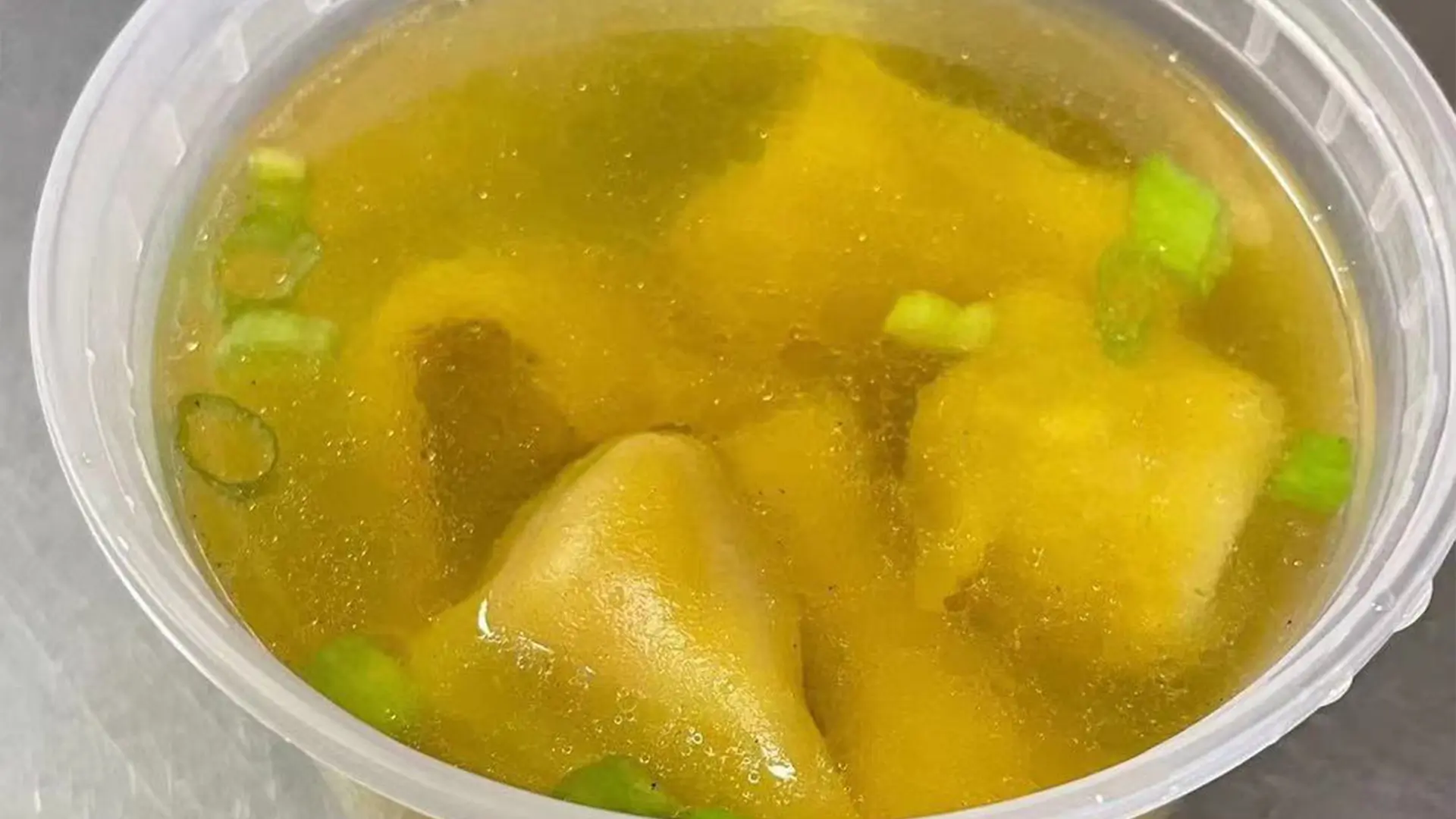 Wonton soup garnished with chopped green onions at New Panda Restaurant, a Chinese Restaurant in Garner